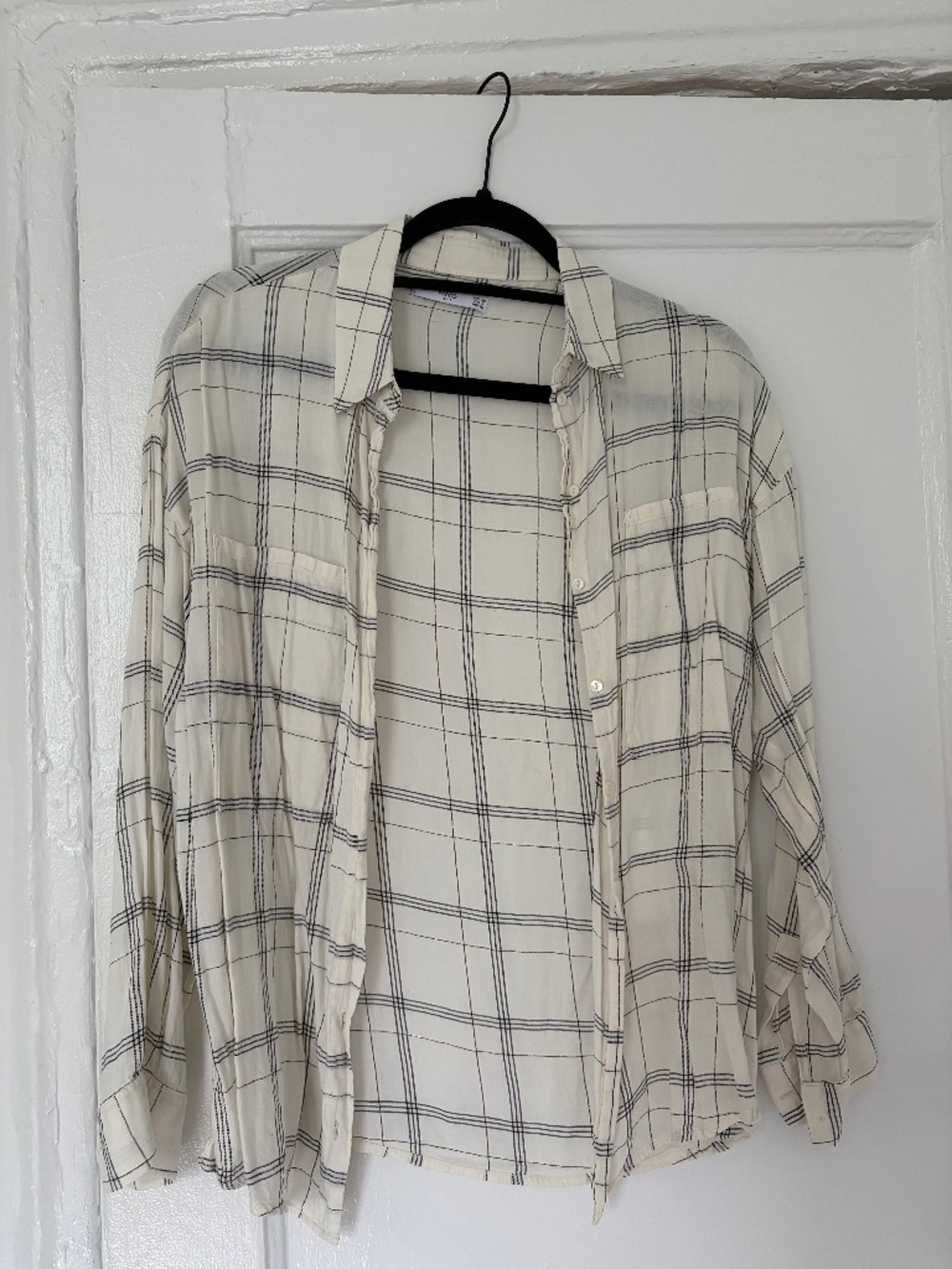 White button down shirt with black-gold plaid details.
